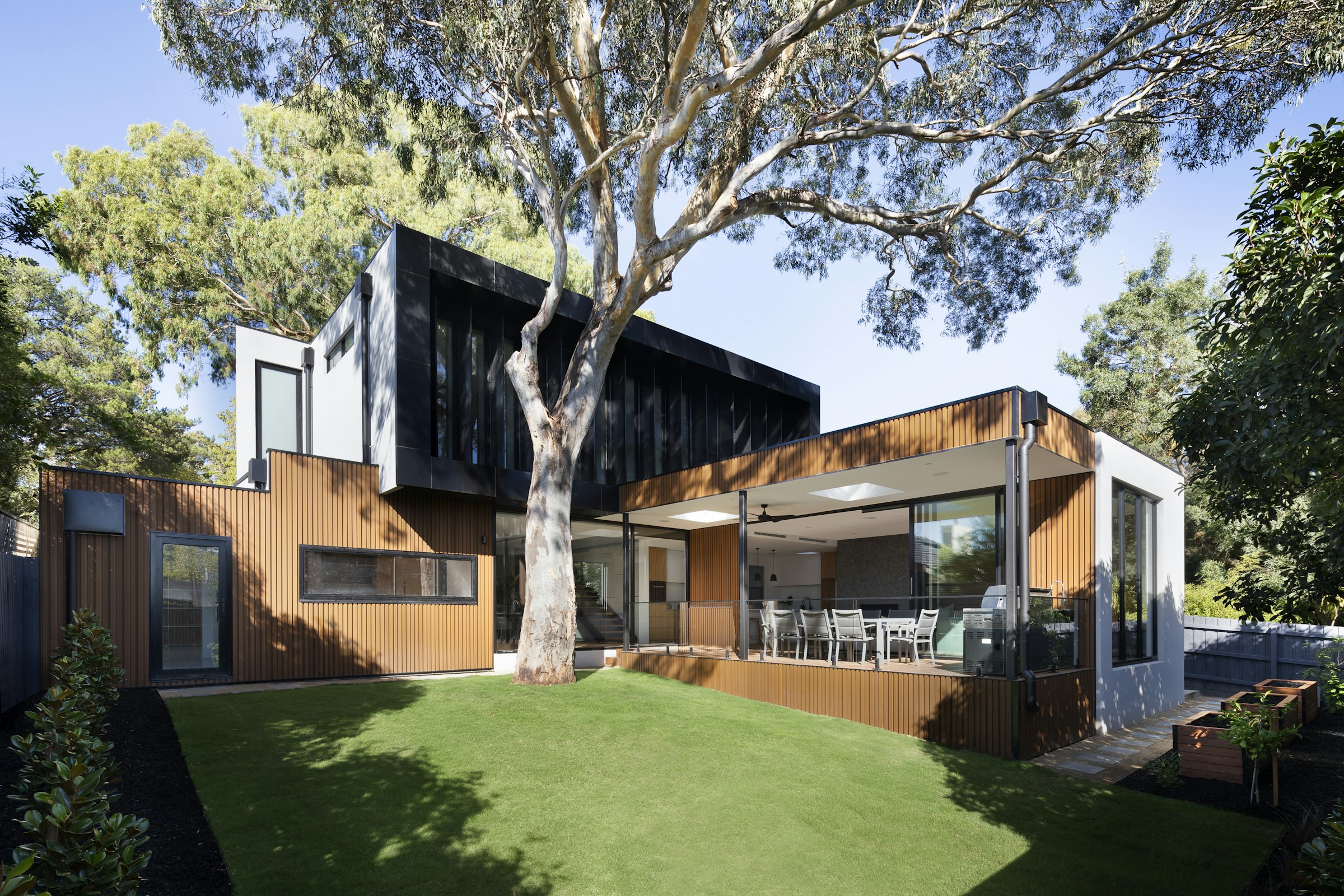 Contemporary two-story house nestled in woodland
